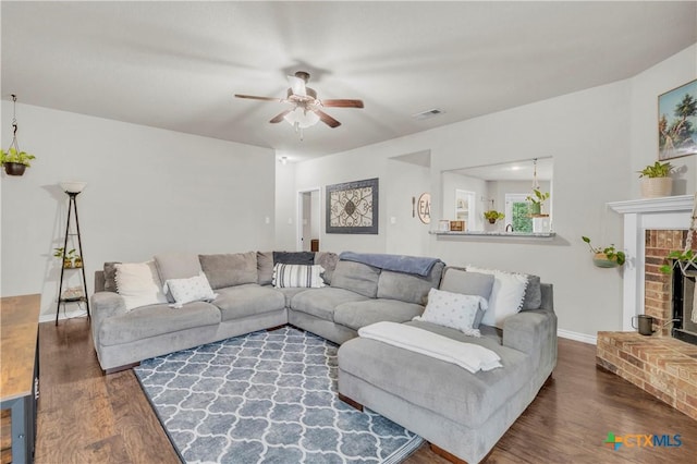6402 Castle Gap Dr, Killeen, TX 76549 - living area with wood finished floors, a ceiling fan, and a fireplace