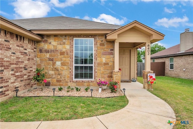 6402 Castle Gap Dr, Killeen, TX 76549 - property entrance featuring stone siding and roof with shingles