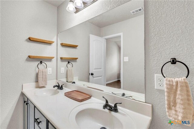 6402 Castle Gap Dr, Killeen, TX 76549 - bathroom featuring a textured wall and double vanity
