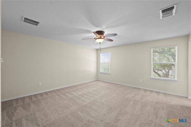 220 Hinge Crk, Cibolo, TX 78108 - carpeted spare room featuring a ceiling fan, baseboards, and a textured ceiling