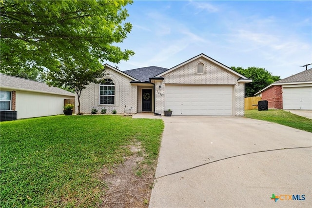 7317 Galleta Ct, Temple, TX 76502 - ranch-style house with a front yard, concrete driveway, brick siding, and a garage