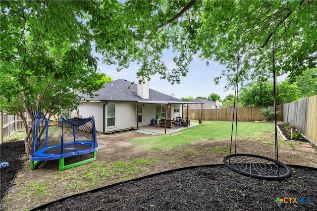 7317 Galleta Ct, Temple, TX 76502 - rear view of property with a trampoline, a chimney, and a patio