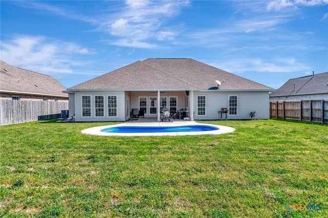 rear view of house with a patio, a yard, and a fenced backyard