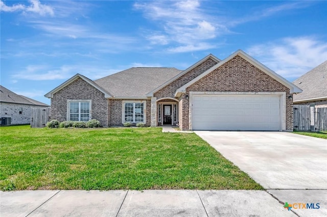 ranch-style house featuring a front yard, fence, an attached garage, concrete driveway, and brick siding