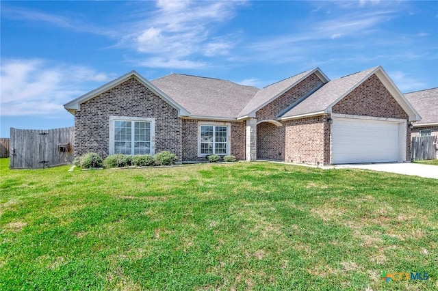 ranch-style house featuring fence, concrete driveway, a front yard, an attached garage, and brick siding