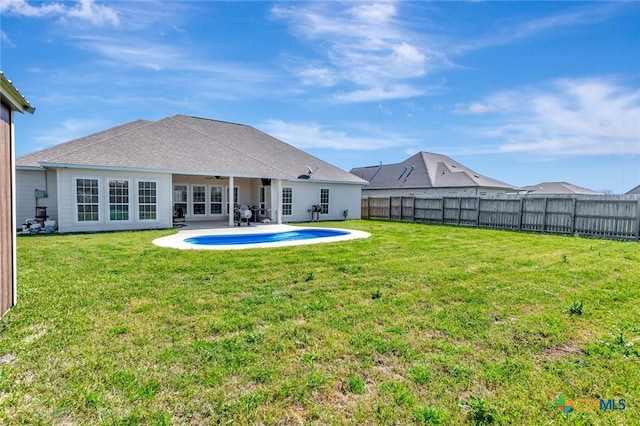 back of property featuring a patio area, a fenced backyard, a lawn, and ceiling fan