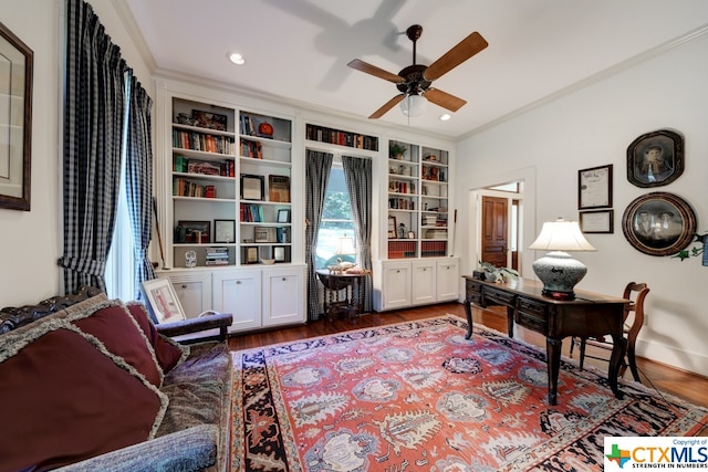 office with built in shelves, ceiling fan, hardwood / wood-style floors, and ornamental molding