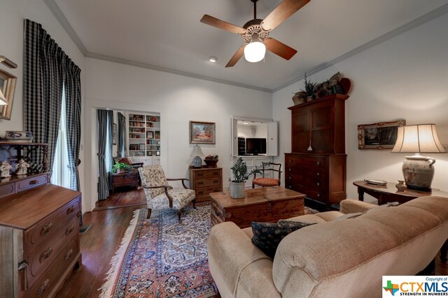 living room with ceiling fan, dark hardwood / wood-style floors, and ornamental molding