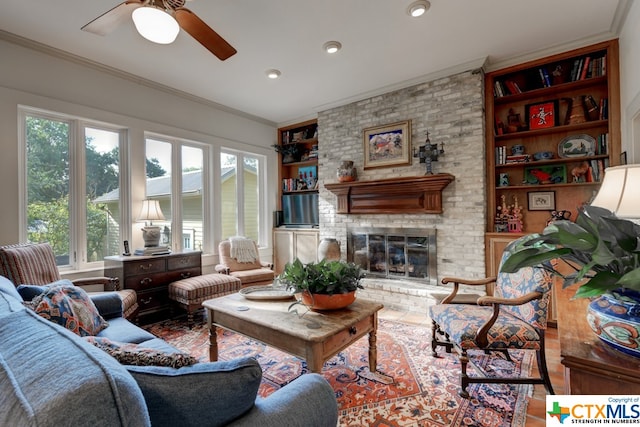 living room with ceiling fan, ornamental molding, and a fireplace