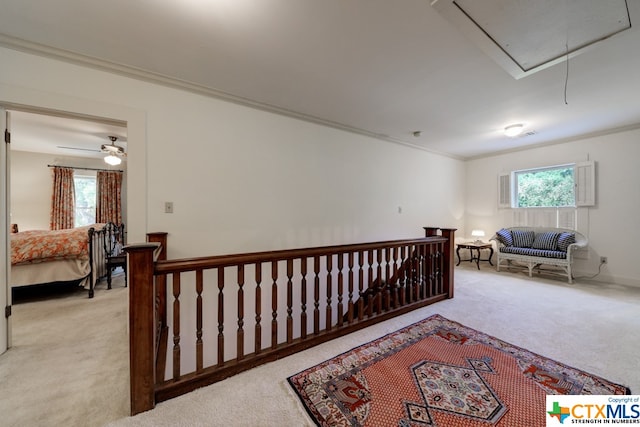 bedroom with ceiling fan, crown molding, light carpet, and multiple windows