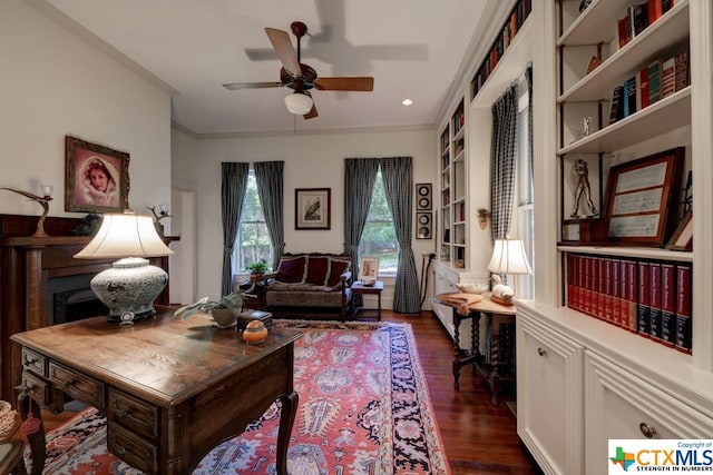 living area with crown molding, built in features, ceiling fan, and dark hardwood / wood-style floors