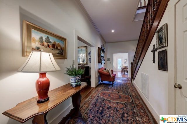 hallway with crown molding and dark wood-type flooring