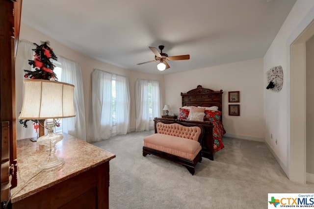 bedroom featuring ceiling fan and light carpet