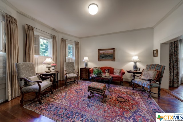 living area featuring dark hardwood / wood-style floors and crown molding