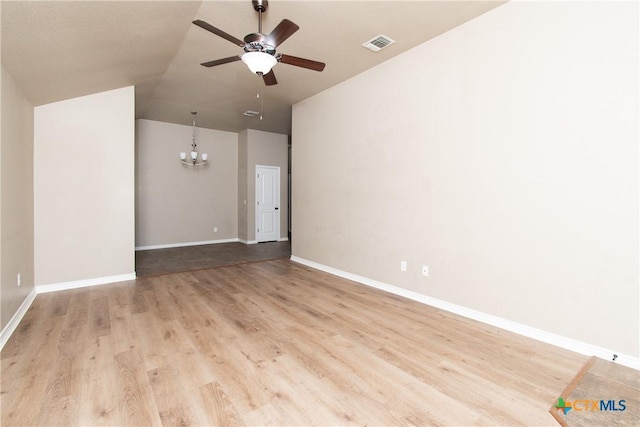 607 Sladecek Dr, Killeen, TX 76542 - empty room featuring ceiling fan, a chandelier, wood finished floors, lofted ceiling, and baseboards