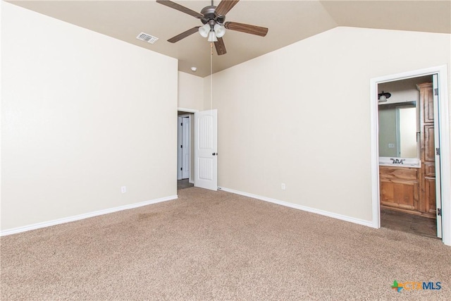 607 Sladecek Dr, Killeen, TX 76542 - unfurnished bedroom featuring carpet, a sink, connected bathroom, baseboards, and high vaulted ceiling