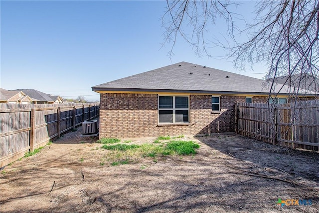 607 Sladecek Dr, Killeen, TX 76542 - rear view of house featuring brick siding, central AC, a fenced backyard, and a shingled roof