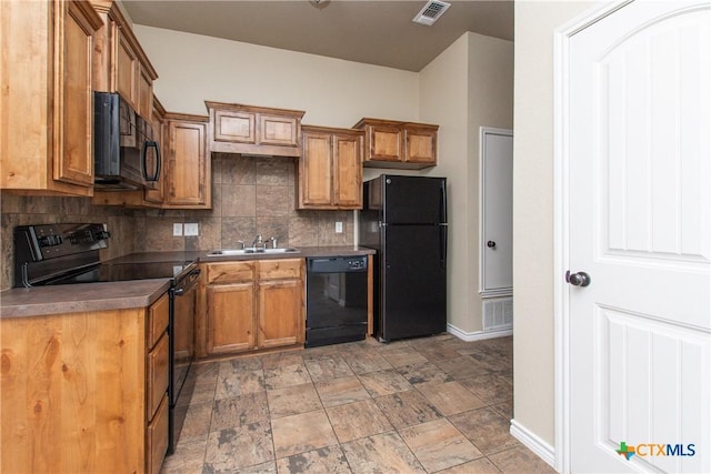 607 Sladecek Dr, Killeen, TX 76542 - kitchen with black appliances, a sink, baseboards, tasteful backsplash, and dark countertops