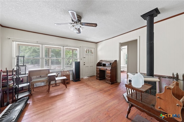 sitting room featuring ornamental molding, a textured ceiling, and hardwood / wood-style flooring