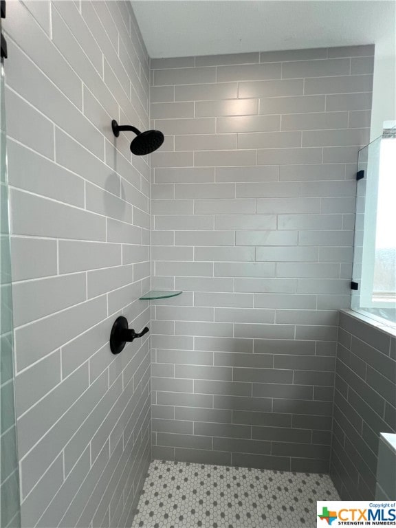 bathroom with tiled shower