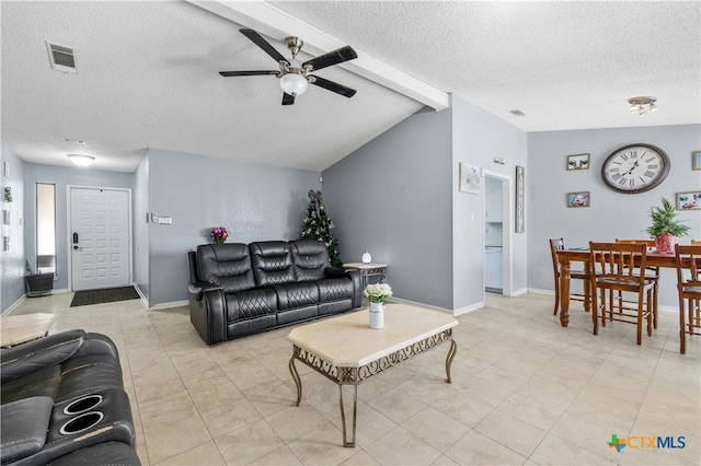 living room with vaulted ceiling with beams, a textured ceiling, and ceiling fan