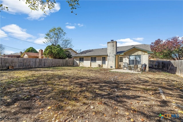 back of house with a patio