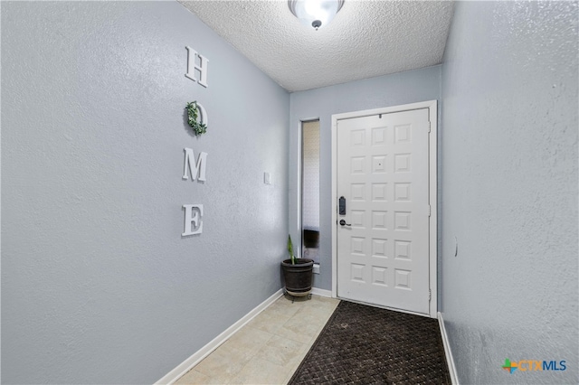 doorway featuring light tile patterned floors and a textured ceiling