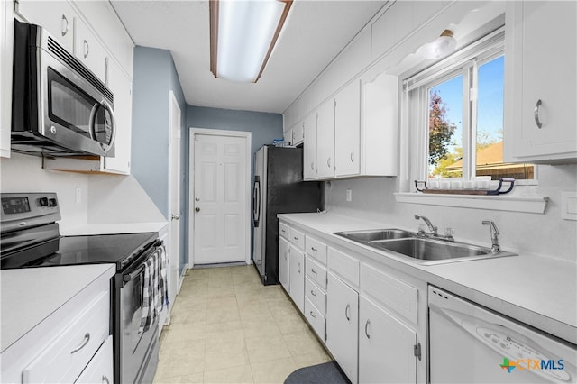 kitchen featuring white cabinets, light tile patterned flooring, sink, and appliances with stainless steel finishes