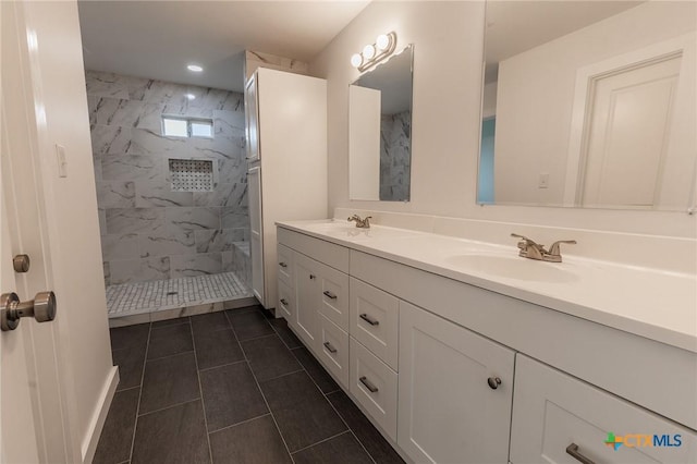 1123 Ainsworth St, Gonzales, TX 78629 - full bath featuring double vanity, a marble finish shower, tile patterned floors, and recessed lighting