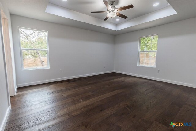 1123 Ainsworth St, Gonzales, TX 78629 - empty room featuring a raised ceiling, dark wood-style flooring, ceiling fan, and recessed lighting