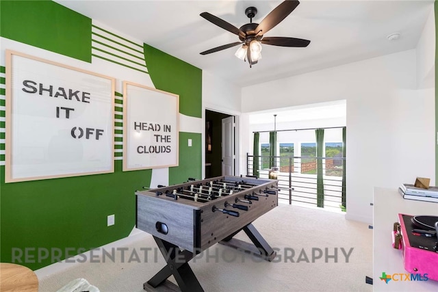 recreation room featuring a ceiling fan and carpet flooring