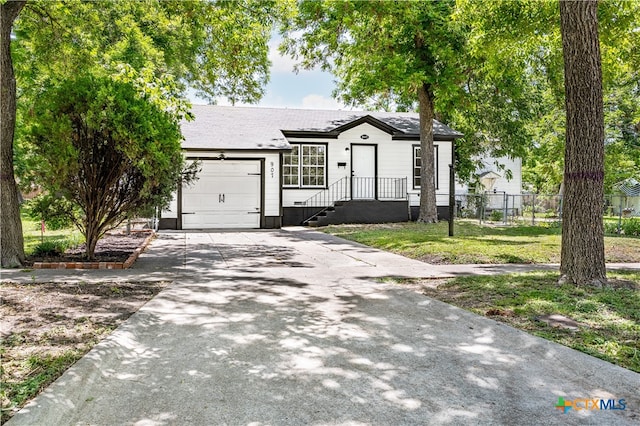 view of front of house with a front yard and a garage