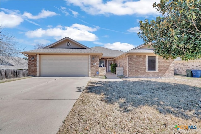 ranch-style home with brick siding, driveway, an attached garage, and fence