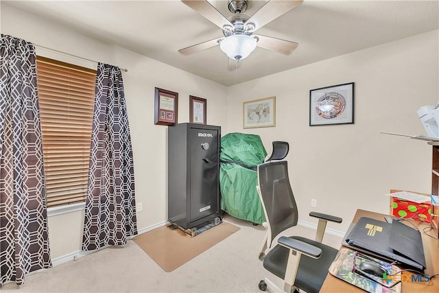 carpeted home office featuring a ceiling fan and baseboards