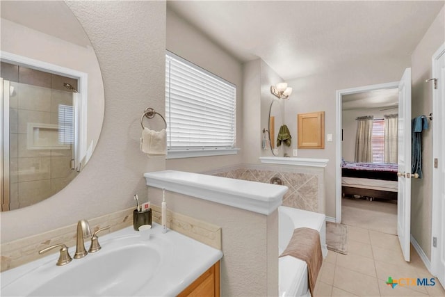 full bath with tile patterned flooring, ensuite bath, vanity, and a garden tub