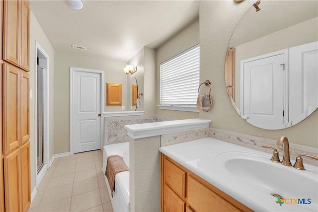 full bathroom featuring tile patterned flooring, a bath, vanity, and visible vents