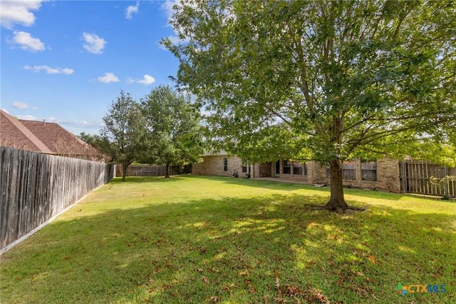 view of yard with a fenced backyard