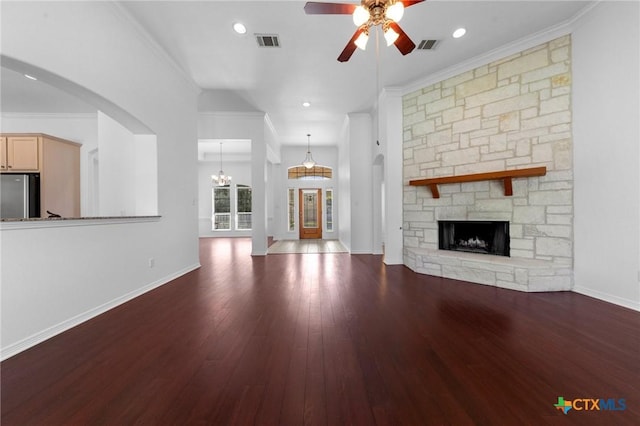 unfurnished living room featuring a ceiling fan, visible vents, wood finished floors, and ornamental molding