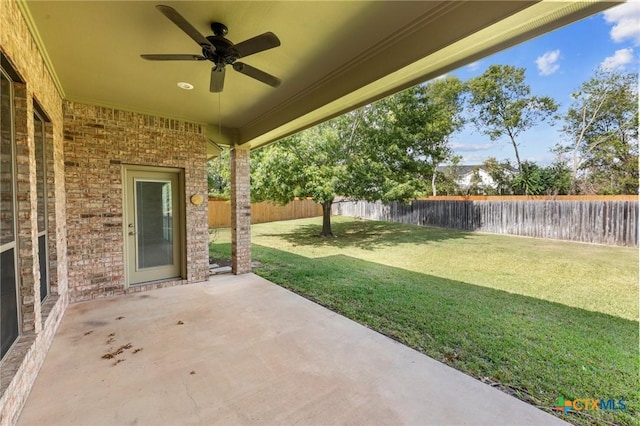 view of patio with a fenced backyard and a ceiling fan