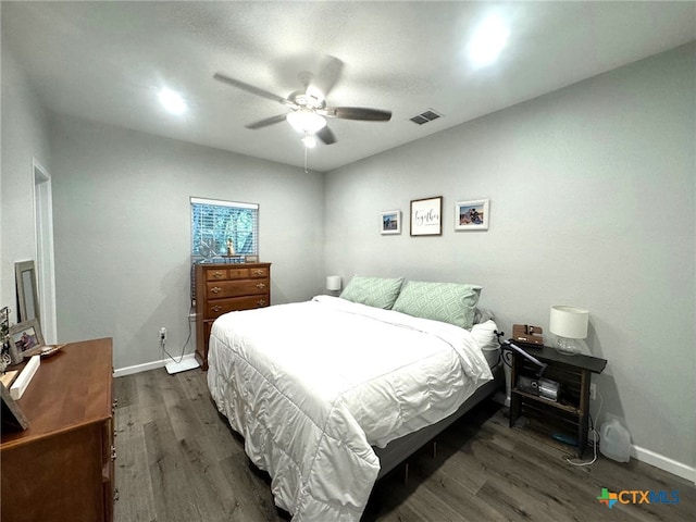 bedroom with ceiling fan and dark hardwood / wood-style flooring