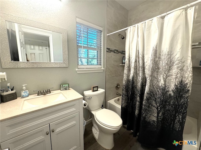 full bathroom featuring shower / bath combo with shower curtain, vanity, and toilet