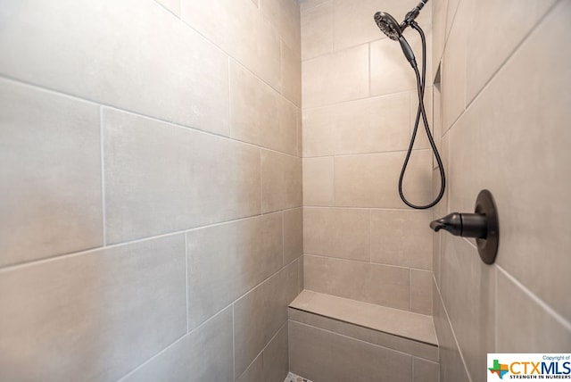 bathroom featuring tiled shower