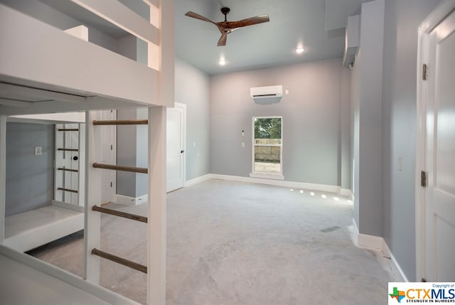 interior space featuring carpet flooring, ceiling fan, and a wall mounted air conditioner