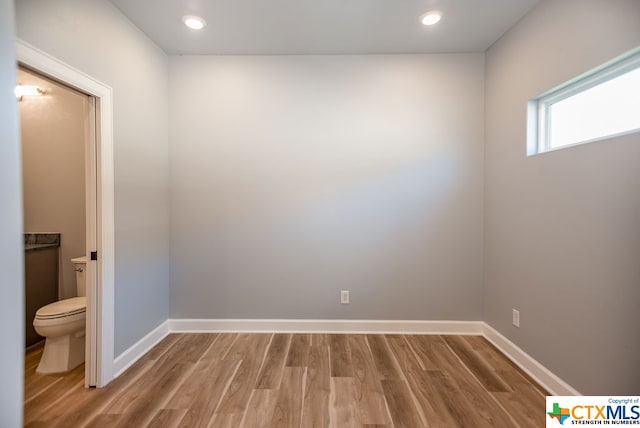 unfurnished room with hardwood / wood-style flooring