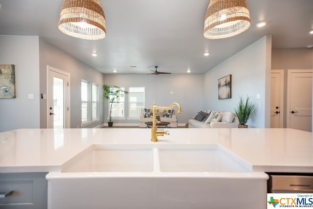 kitchen featuring sink, decorative light fixtures, and ceiling fan