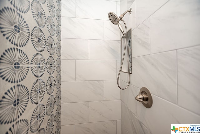 bathroom with tiled shower