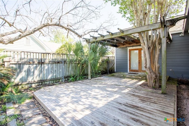 deck featuring a fenced backyard and a pergola