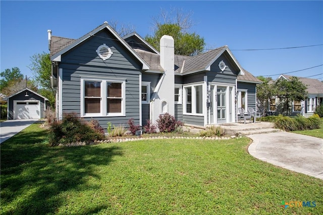 view of front of house with a detached garage, an outdoor structure, a chimney, and a front lawn