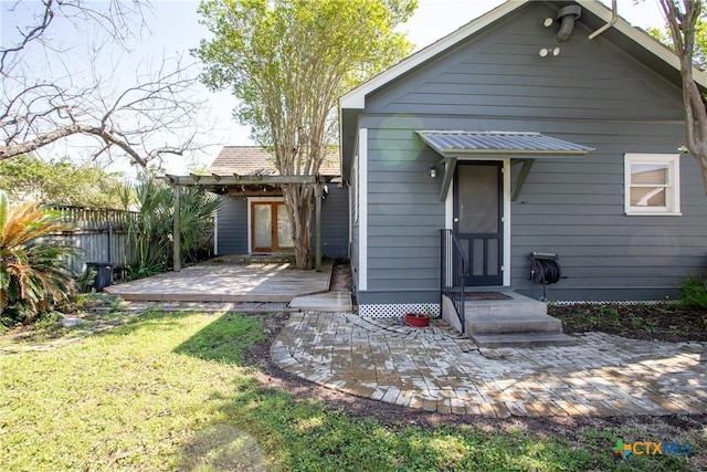 rear view of house with fence, a patio, and a yard