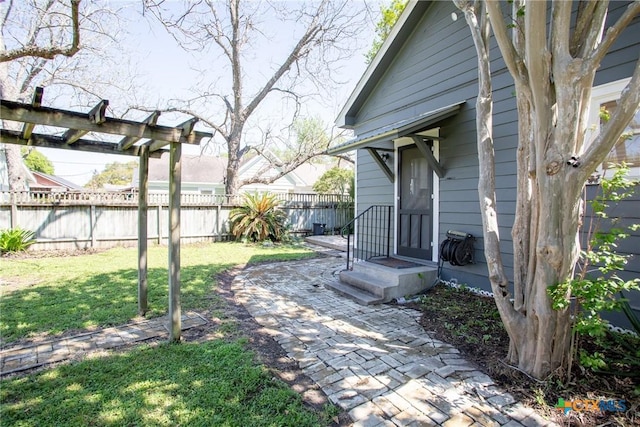 view of yard featuring fence and a patio